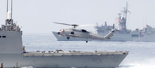A Taiwan Navy S70 helicopter takes off from the stern of a Perry-class frigate during a navy exercise in the bound of Suao naval station in Yilan County, northeast of Taiwan, Friday, April 13, 2018 A Taiwan Navy S70 helicopter takes off from the stern of a Perry-class frigate during a navy exercise in the bound of Suao naval station in Yilan County, northeast of Taiwan, Friday, April 13, 2018 - Sputnik International