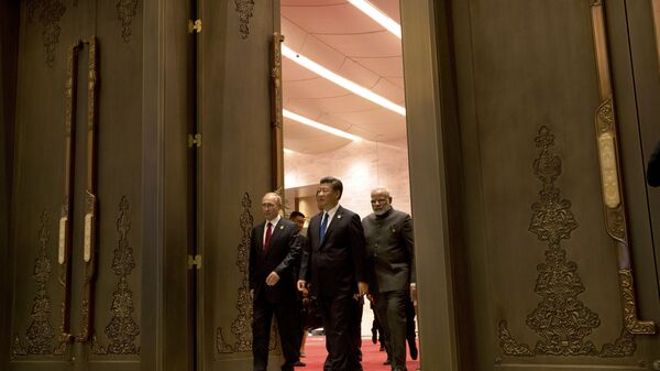 (L to R) Russian President Vladimir Putin, Chinese President Xi Jinping and Indian Prime Minister Narendra Modi arrive for the Dialogue of Emerging Market and Developing Countries on the sidelines of the 2017 BRICS Summit in Xiamen, southeastern China's Fujian Province on September 5, 2017 - Sputnik International