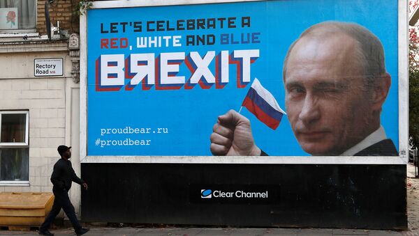 A man walks past a billboard poster in London, Britain, November 8, 2018 - Sputnik International