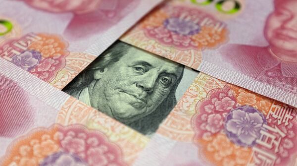 A US 100-dollar banknote with a portrait of Benjamin Franklin and Chinese 100-yuan banknotes with portrait of late Chinese Chairman Mao Zedong are seen in the picture illustration in Beijing, China - Sputnik International