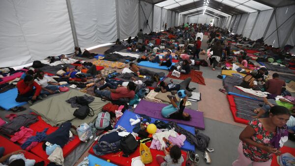 Central American migrants, part of a caravan hoping to reach the U.S. gets settled in a shelter at the Jesus Martinez stadium, in Mexico City, Monday, Nov. 5, 2018. Thousands of Central American migrants have arrived at the stadium, still hundreds of miles away from their goal of reaching the U.S. a day before midterm elections in which they unwittingly became a central issue. - Sputnik International