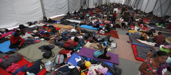Central American migrants, part of a caravan hoping to reach the U.S. gets settled in a shelter at the Jesus Martinez stadium, in Mexico City, Monday, Nov. 5, 2018. Thousands of Central American migrants have arrived at the stadium, still hundreds of miles away from their goal of reaching the U.S. a day before midterm elections in which they unwittingly became a central issue. - Sputnik International