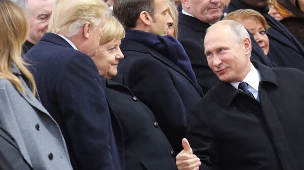 Russian President Vladimir Putin talks with German Chancellor Angela Merkel and US President Donald Trump as they attend a ceremony at the Arc de Triomphe in Paris, as part of commemorations marking the 100th anniversary of the 11 November 1918 armistice, ending World War I, Sunday, Nov. 11, 2018. - Sputnik International