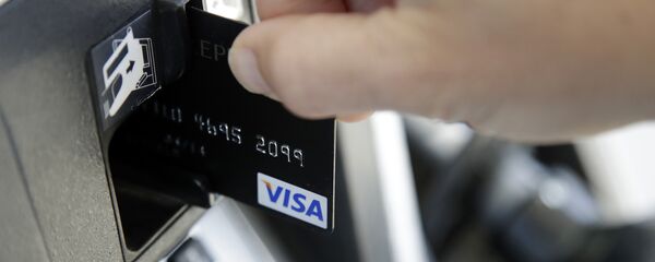 a customer inserts a credit card to buy gas a customer inserts a credit card to buy gas - Sputnik International