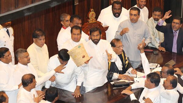 A dustbin is thrown towards Sri Lanka's parliament speaker Karu Jayasuriya during a parliament session in Colombo, Sri Lanka November 15, 2018. - Sputnik International