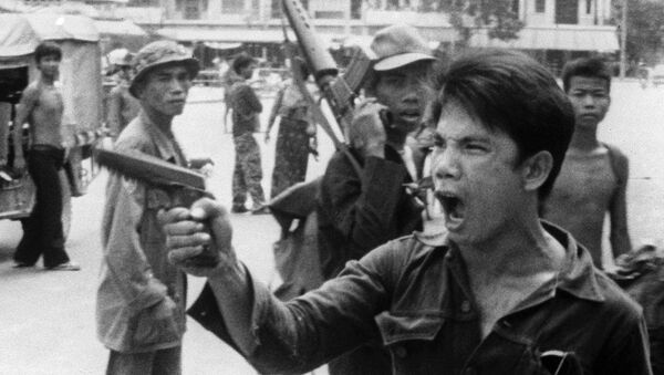FILE - In this April 17, 1975 , file photo, a Khmer Rouge soldier waves his pistol and orders store owners to abandon their shops in Phnom Penh, Cambodia on as the capital fell to the communist forces - Sputnik International