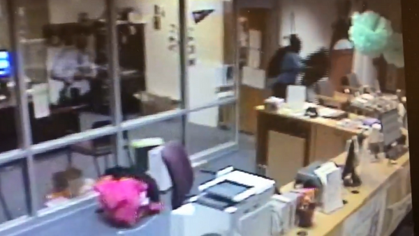 Atlanta's Channel 2 Action News obtains surveillance footage showing former school employee body slamming student onto a desk - Sputnik International