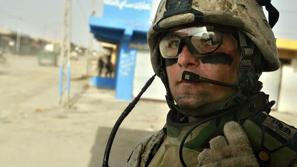 U.S. Marine Sgt. Derek McGee, of Rhinebeck, New York, speaks into his radio during a patrol in Fallujah, the site of the largest U.S. battle in Iraq, 65 kilometers (40 miles), west of Baghdad, Iraq, Monday, May 1, 2006 - Sputnik International