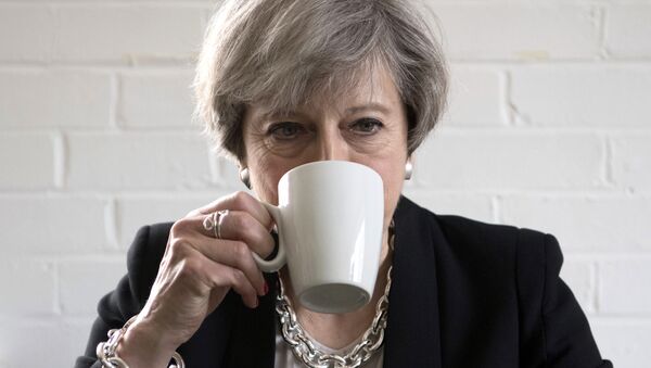 Britain's Prime Minister Theresa May drinks from a mug as she meets youth activists during a visit to the Young Minds mental health charity while on the election campaign trail, in London, Thursday May 11, 2017. Britain will hold a general election on June 8. - Sputnik International