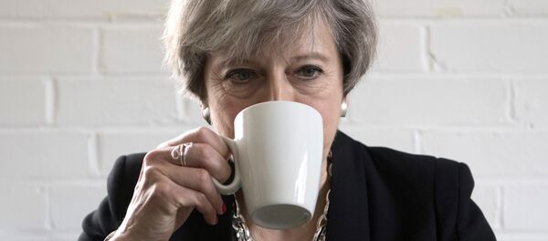 Britain's Prime Minister Theresa May drinks from a mug as she meets youth activists during a visit to the Young Minds mental health charity while on the election campaign trail, in London, Thursday May 11, 2017. Britain will hold a general election on June 8. - Sputnik International