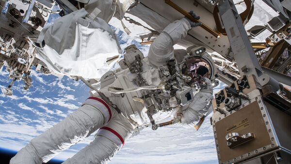 NASA astronaut Drew Feustel seemingly hangs off the International Space Station while conducting a spacewalk with fellow NASA astronaut Ricky Arnold (out of frame) on March 29, 2018. Feustel, as are all spacewalkers, was safely tethered at all times to the space station during the six-hour, ten-minute spacewalk. - Sputnik International