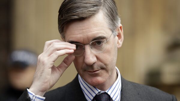 Pro-Brexit, Conservative lawmaker Jacob Rees-Mogg adjusts his glasses as he speaks to the media outside the Houses of Parliament in London, Thursday, Nov. 15, 2018.  - Sputnik International