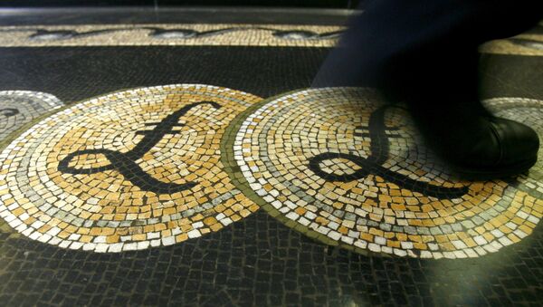 An employee is seen walking over a mosaic of pound sterling symbols set in the floor of the front hall of the Bank of England in London - Sputnik International