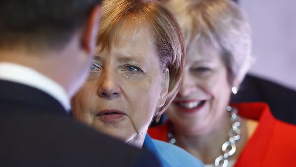 German Chancellor Angela Merkel, left, and British Prime Minister Theresa May wait for the beginning of the plenary session of the informal EU summit in Salzburg, Austria, Thursday, Sept. 20, 2018. - Sputnik International