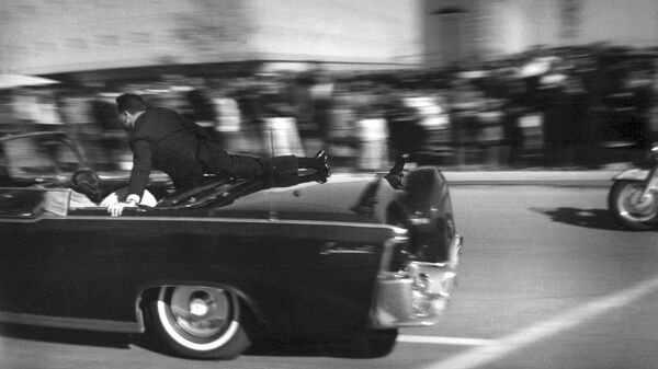 FILE - In this Nov. 22, 1963 file photo, the limousine carrying mortally wounded President John F. Kennedy races toward the hospital seconds after he was shot in Dallas. Secret Service agent Clinton Hill is riding on the back of the car, Nellie Connally, wife of Texas Gov. John Connally, bends over her wounded husband, and first lady Jacqueline Kennedy leans over the president. The National Archives has until Oct. 26, 2017, to disclose the remaining files related to Kennedy's assassination, unless President Donald Trump intervenes.  - Sputnik International
