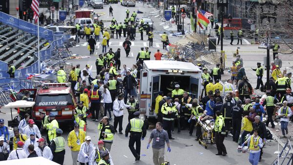 Medical workers aid injured people at the finish line of the 2013 Boston Marathon following an explosion in Boston, Monday, April 15, 2013 - Sputnik International