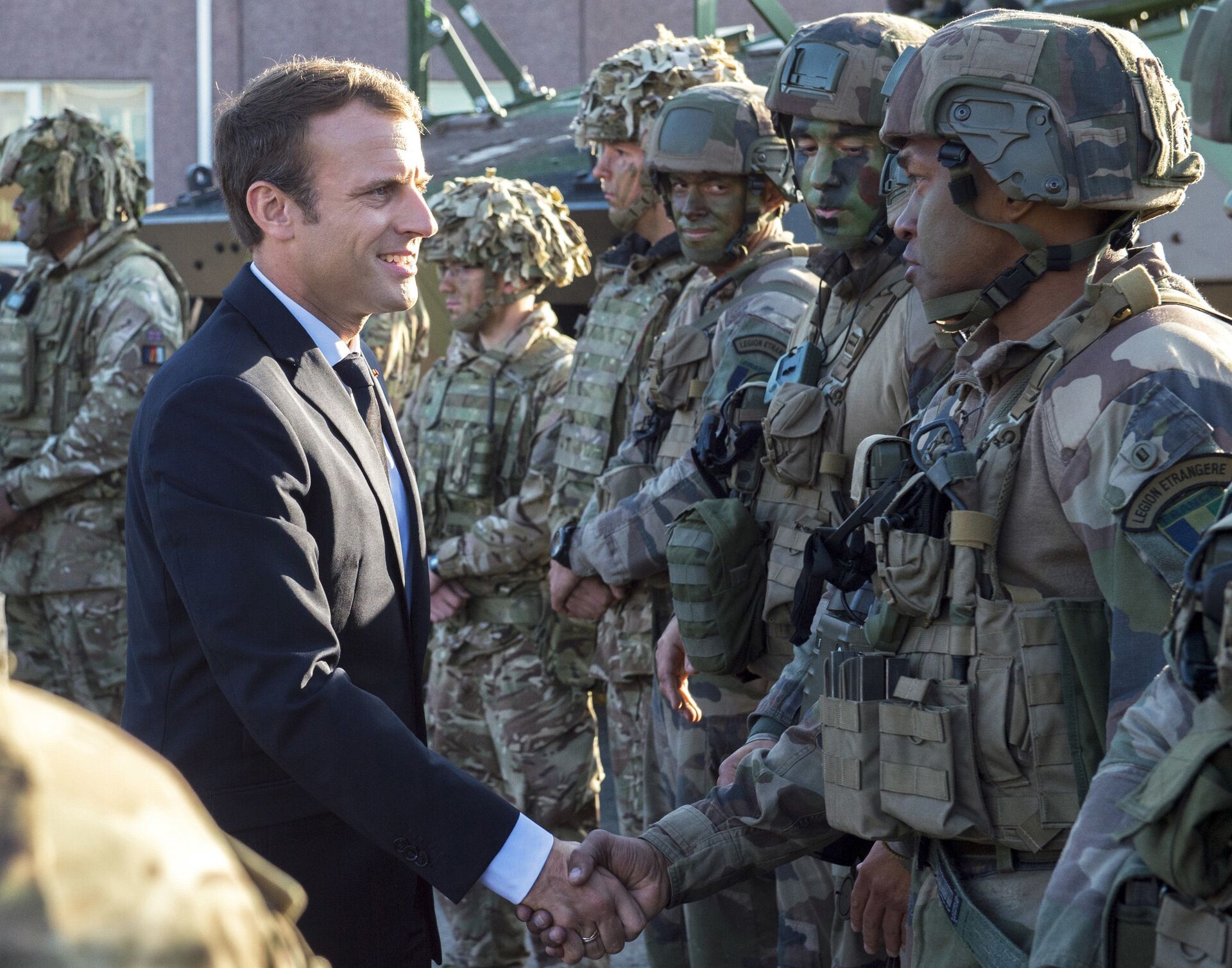 FILE - In this Friday, Sept. 29, 2017 file photo, France's President Emmanuel Macron, left, shakes hands with French soldiers of the NATO Battle Group at the Tapa military base, about 90 kilometers (56 miles) west of Tallinn, Estonia - Sputnik International, 1920, 08.12.2021