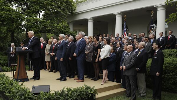 President Donald Trump, accompanied by House GOP members, speaks in the Rose Garden of the White House in Washington, Thursday, May 4, 2017, after the House pushed through a health care bill - Sputnik International
