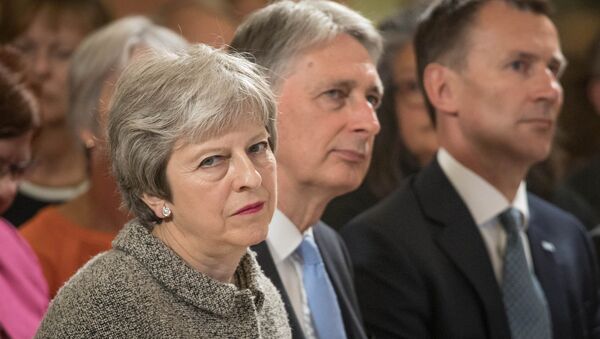 Britain's Prime Minister Theresa May sits next to Chancellor of the Ecxhequer Philip Hammond, and Health Secretary Jeremy Hunt during an event at the Royal Free Hospital, London June 18, 2018 - Sputnik International