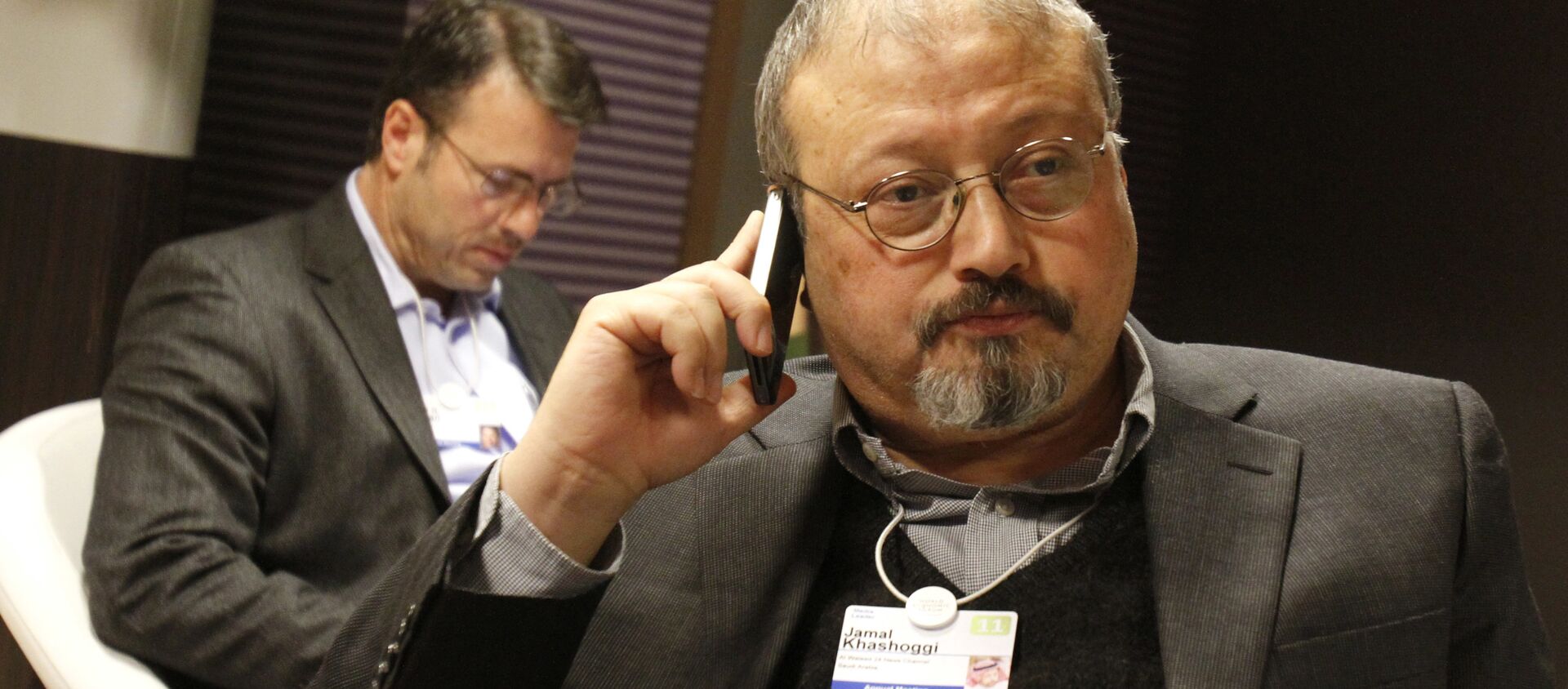 FILE - In this Jan. 29, 2011 file photo, Saudi journalist Jamal Khashoggi speaks on his cellphone at the World Economic Forum in Davos, Switzerland. Khashoggi was a Saudi insider - Sputnik International, 1920, 22.06.2021