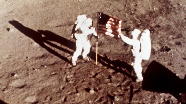 Apollo 11 astronauts Neil Armstrong and Edwin E. Buzz Aldrin, the first men to land on the moon, plant the U.S. flag on the lunar surface, July 20, 1969. Photo was made by a 16mm movie camera inside the lunar module, shooting at one frame per second - Sputnik International