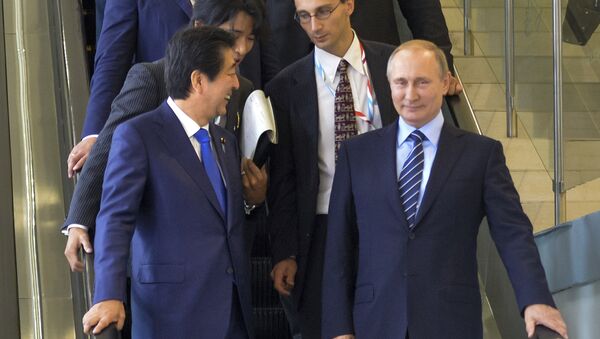 Japanese Prime Minister Shinzo Abe, left, and Russian President Vladimir Putin come down on the escalator after their talks in Vladivostok, Russia, Friday, Sept. 2, 2016 - Sputnik International