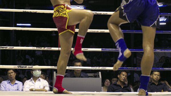 In this Friday, Feb. 7, 2014 photo, veteran judges watch two Muay Thai kick boxers during the last fight night of the famed Lumpinee Boxing Stadium in Bangkok, Thailand - Sputnik International
