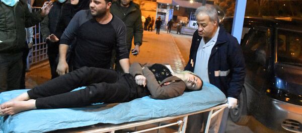 A woman lies on a stretcher after what the Syrian state media said was a suspected toxic gas attack in Aleppo, Syria November 24, 2018 - Sputnik International