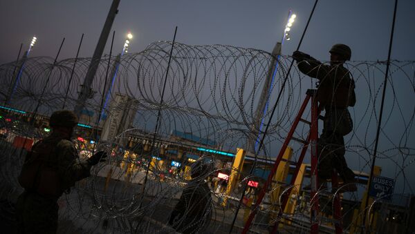 United States Marines fortify concertina wire along the San Ysidro Port of Entry border crossing as seen from Tijuana - Sputnik International