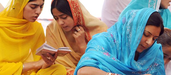 Indian Sikh devotees read the Sikh Holy Book at the Gurdawara Dera Sahibin in Lahore on June 16, 2006. - Sputnik International