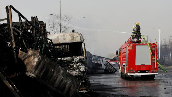 Firefighters work next to burnt vehicles following a blast near a chemical plant in Zhangjiakou. - Sputnik International