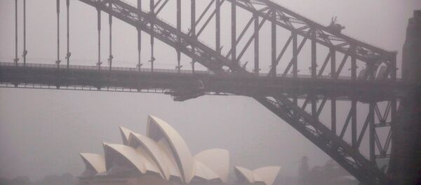 A boat passes under the Sydney Harbour Bridge and in front of the Sydney Opera House as strong winds and heavy rain hit the city of Sydney, Australia, November 28, 2018 - Sputnik International