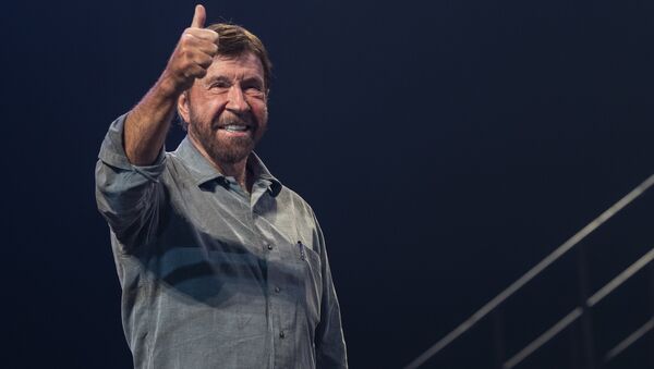 US actor and martial artist Chuck Norris, this year's special guest signals to the audience onstage during the opening gala of the 15th Shoe Box fundraising event in Papp Laszlo Sports Arena in Budapest, Hungary, Saturday, Nov. 24, 2018 - Sputnik International