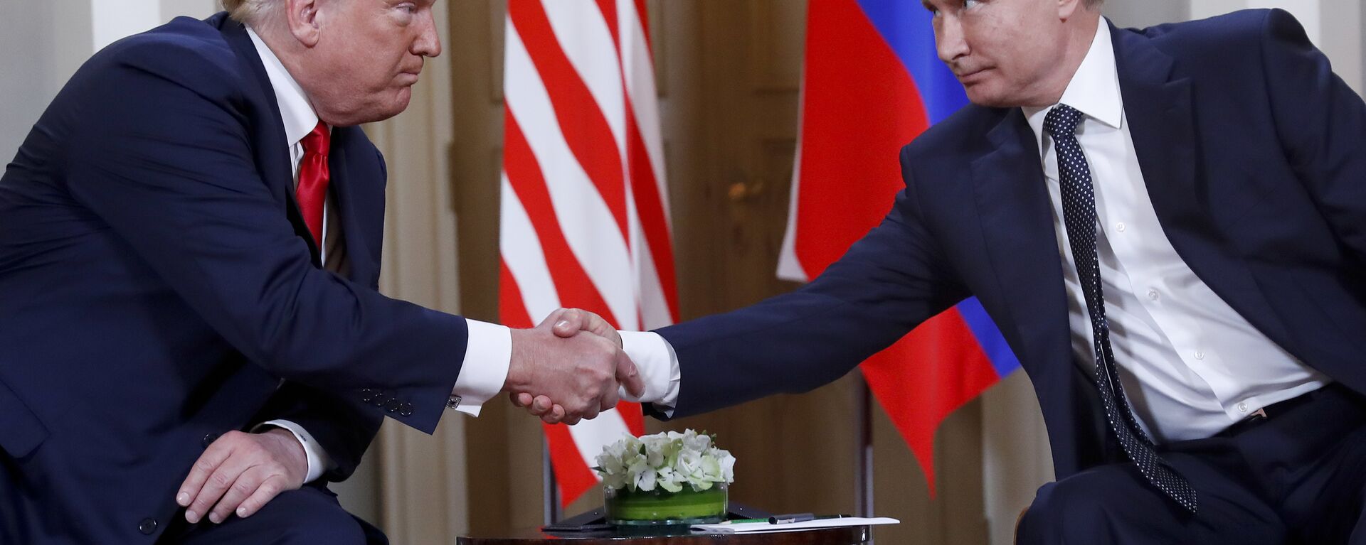 In this file photo taken on Monday, July 16, 2018, U.S. President Donald Trump, left, and Russian President Vladimir Putin, shake hands at the beginning of a meeting at the Presidential Palace in Helsinki, Finland. - Sputnik International, 1920, 19.05.2025