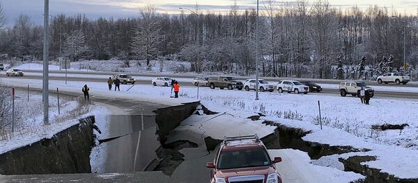 A car is trapped on a collapsed section of the offramp of Minnesota Drive in Anchorage, Friday, Nov. 30, 2018. - Sputnik International