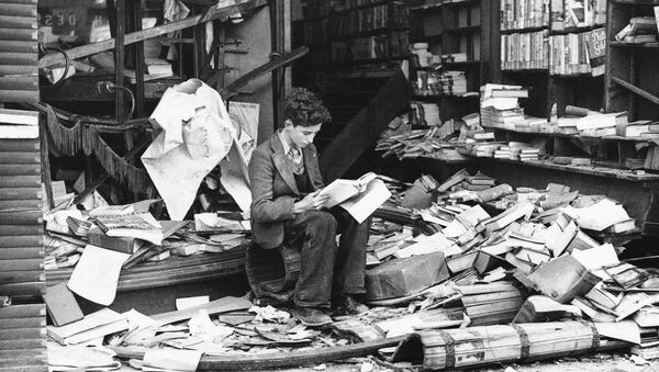 a boy sits amid the ruins of a London bookshop following an air raid on Oct. 8, 1940 - Sputnik International