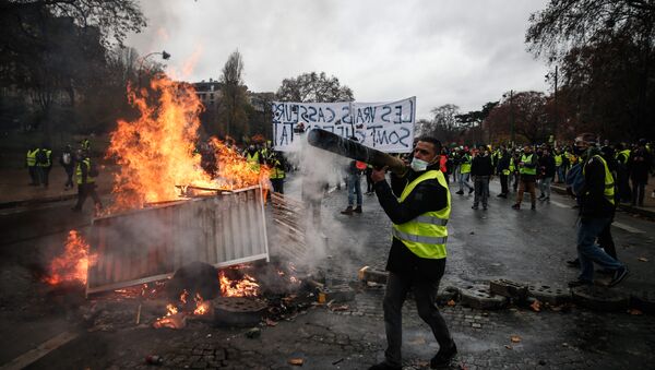 Protesters build a barricade during a protest of Yellow vests (Gilets jaunes) against rising oil prices and living costs, on December 1, 2018 in Paris - Sputnik International