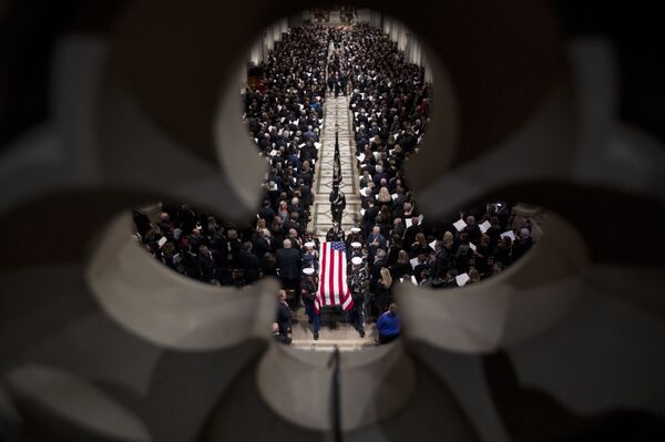 The flag-draped casket of former President George H.W. Bush is carried out by a military honor guard during a State Funeral at the National Cathedral The flag-draped casket of former President George H.W. Bush is carried out by a military honor guard during a State Funeral at the National Cathedral - Sputnik International
