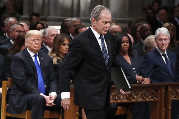 Former President George W. Bush walks past President Donald Trump, first lady Melania Trump, Michelle Obama and former President Bill Clinton to give a eulogy for his father Former President George W. Bush walks past President Donald Trump, first lady Melania Trump, Michelle Obama and former President Bill Clinton to give a eulogy for his father - Sputnik International