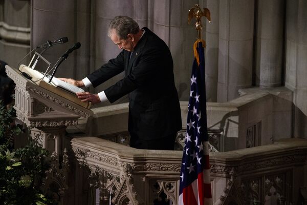 Former President George W. Bush fights back tears as he speaks during the State Funeral for his father, former President George H.W. Bush, at the National Cathedral Former President George W. Bush fights back tears as he speaks during the State Funeral for his father, former President George H.W. Bush, at the National Cathedral - Sputnik International