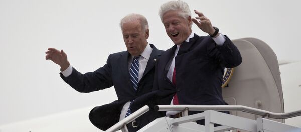 Vice President Joe Biden, left, accompanied by former President Bill Clinton walk carefully off Air Force Two during a rainstorm,, upon their arrival in Youngstown, Ohio, for a campaign stop, Monday, Oct. 29, 2012. Vice President Joe Biden, left, accompanied by former President Bill Clinton walk carefully off Air Force Two during a rainstorm,, upon their arrival in Youngstown, Ohio, for a campaign stop, Monday, Oct. 29, 2012. - Sputnik International