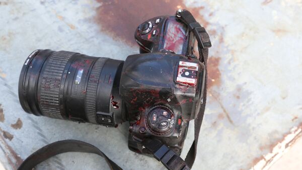 ATTENTION EDITORS - VISUALS COVERAGE OF SCENES OF DEATH OR INJURY - The blood stained camera of a photojournalist is seen after a secondary explosion in front of Dayah hotel in Somalia's capital Mogadishu - Sputnik International