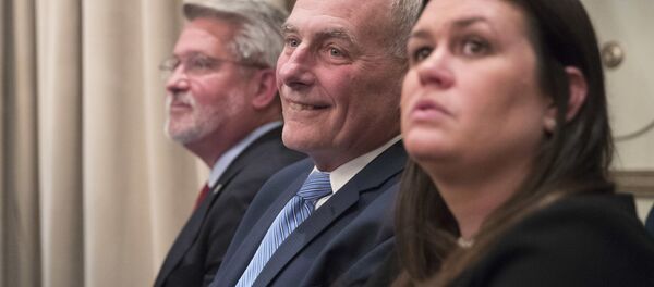 Communications Chief Bill Shine, left, Chief of Staff John Kelly, center, White House Press Secretary Sarah Huckabee Sanders listen as President Donald Trump speaks during a news conference, Wednesday, Sept. 26, 2018, in New York Communications Chief Bill Shine, left, Chief of Staff John Kelly, center, White House Press Secretary Sarah Huckabee Sanders listen as President Donald Trump speaks during a news conference, Wednesday, Sept. 26, 2018, in New York - Sputnik International