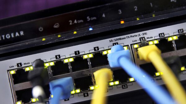 In this June 19, 2018, file photo a router and internet switch are displayed in East Derry, N.H. Net neutrality traces back to an engineering maxim called the “end-to-end principle,” a self-regulating network that put control in the hands of end users rather than a central authority - Sputnik International