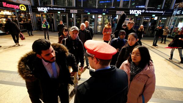 Commuters line up in front of an information counter of Deutsche Bahn during a rail workers' strike across the country due to a pay dispute with Deutsche Bahn, in Cologne, Germany December 10, 2018 - Sputnik International