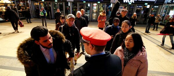 Commuters line up in front of an information counter of Deutsche Bahn during a rail workers' strike across the country due to a pay dispute with Deutsche Bahn, in Cologne, Germany December 10, 2018 - Sputnik International
