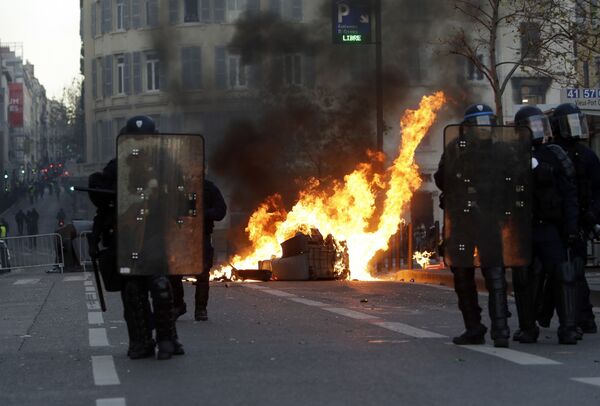 Riot police officer stand in front a burning trash bin during clashes, Saturday, Dec. 8, 2018 in Marseille, southern France Riot police officer stand in front a burning trash bin during clashes, Saturday, Dec. 8, 2018 in Marseille, southern France - Sputnik International
