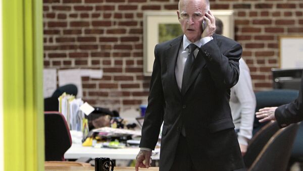 Governor Jerry Brown is seen on the phone after Tuesday's election at his campaign headquarters in Oakland, Calif. (File) - Sputnik International