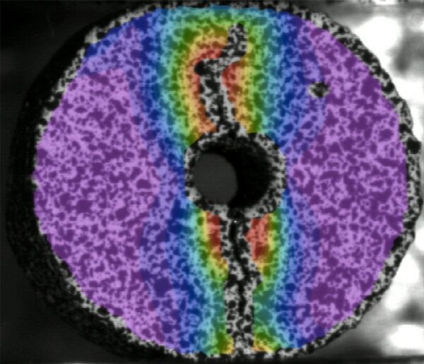 A coloured picture of the distribution of deformations at surface points of a cast iron specimen with a hole A coloured picture of the distribution of deformations at surface points of a cast iron specimen with a hole - Sputnik International