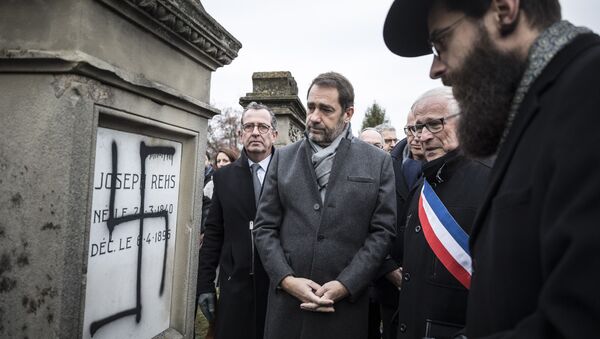 French Interior Minister Christophe Castaner, center, attends a ceremony at the Jewish cemetery of Herrlisheim, near Strasbourg, eastern France, with Strasbourg Rabi Harold Weill, right, and local mayor Louis Becker, second right, Friday, Dec.14, 2018. - Sputnik International